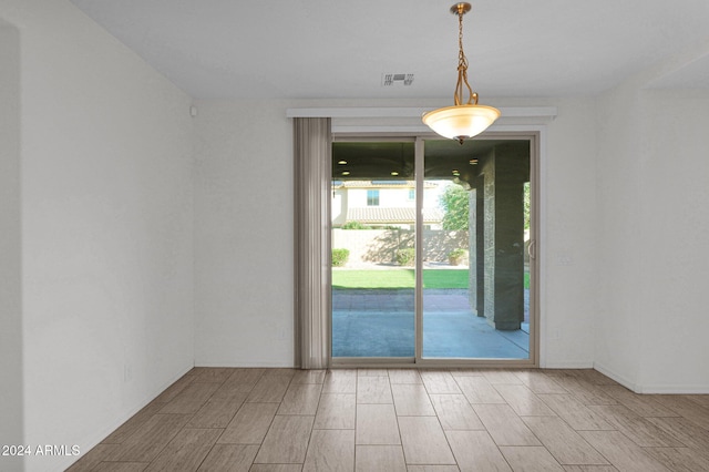 unfurnished room with wood-type flooring