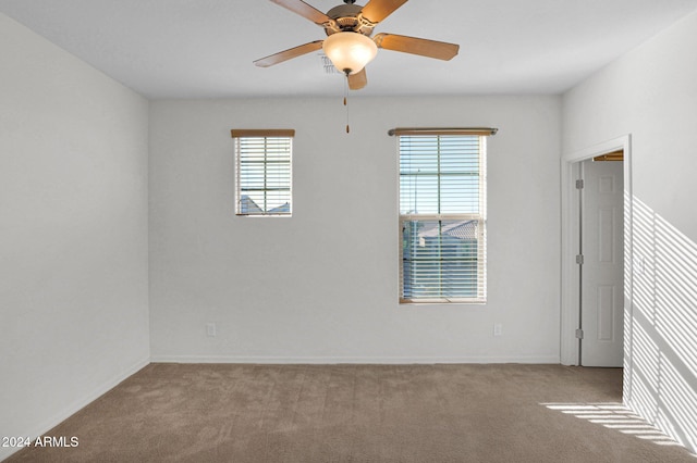 spare room with light carpet and ceiling fan