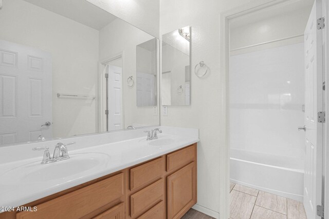 bathroom with vanity and bathing tub / shower combination