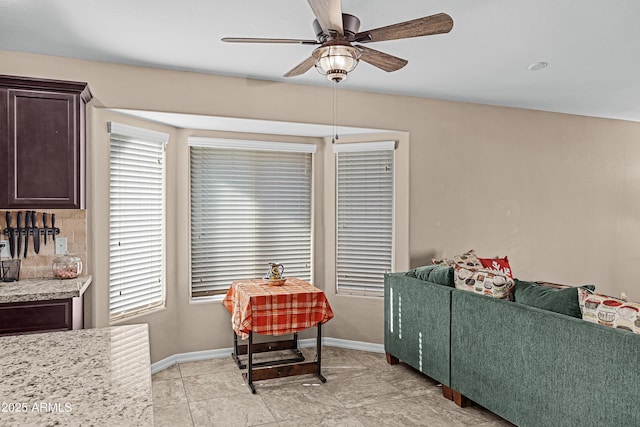 living room with light tile patterned floors and ceiling fan