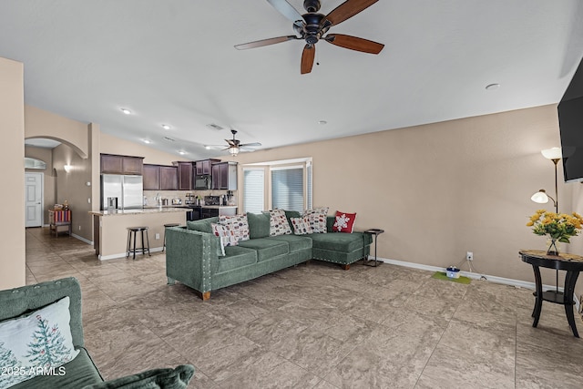 living room with ceiling fan and vaulted ceiling