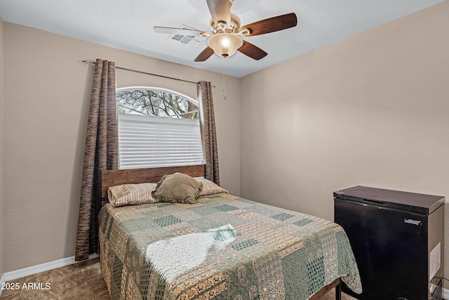 carpeted bedroom featuring ceiling fan and fridge