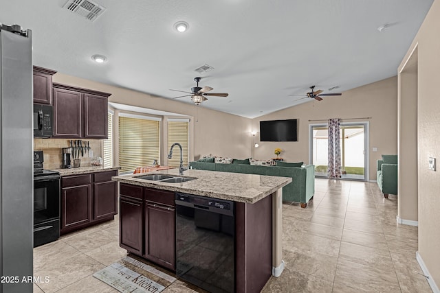 kitchen featuring lofted ceiling, black appliances, sink, an island with sink, and dark brown cabinets