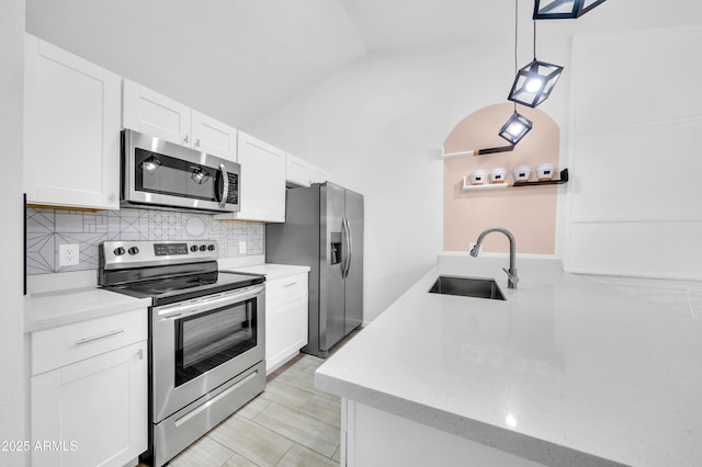 3201 W Mohawk Ln, Phoenix, AZ 85027 - kitchen featuring stainless steel appliances, a sink, decorative backsplash, white cabinets, and vaulted ceiling