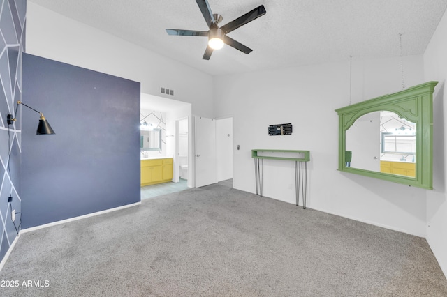 3201 W Mohawk Ln, Phoenix, AZ 85027 - empty room featuring carpet flooring, ceiling fan, vaulted ceiling, a textured ceiling, and baseboards