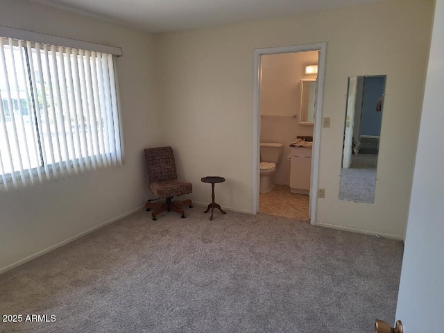 unfurnished bedroom featuring carpet flooring, baseboards, and connected bathroom