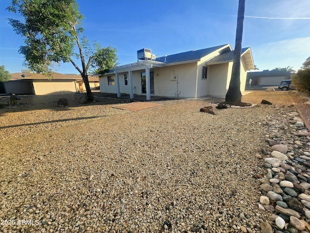 back of property featuring cooling unit