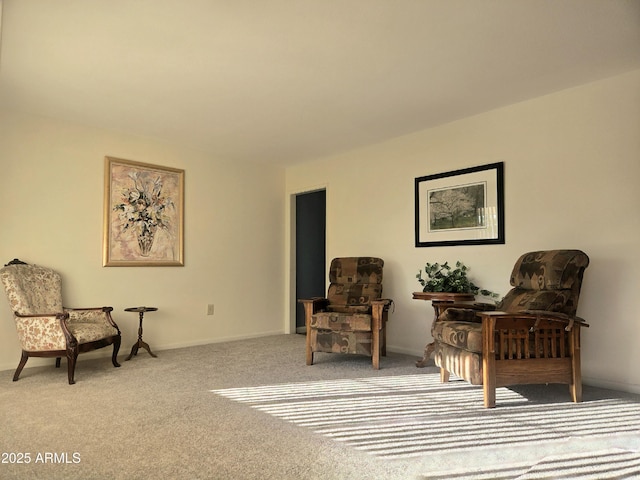 living area with baseboards and carpet