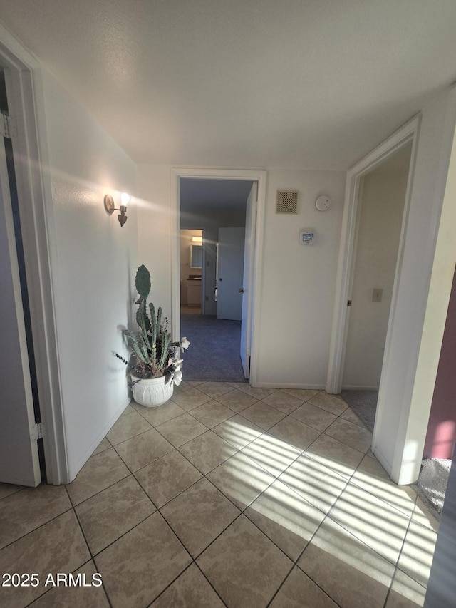 hall with tile patterned floors and visible vents