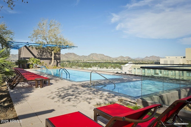 view of pool featuring a patio and a mountain view