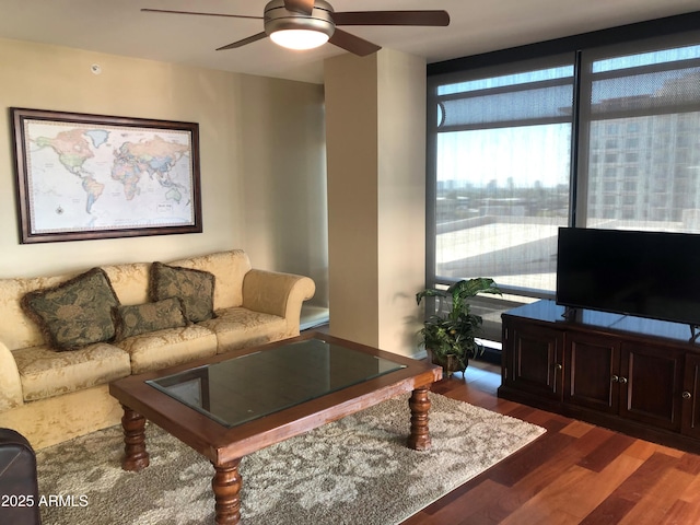 living room with ceiling fan and dark hardwood / wood-style floors