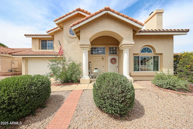 7110 N 28th Dr, Phoenix, AZ 85051 - mediterranean / spanish home with stucco siding, a chimney, a tile roof, and a garage