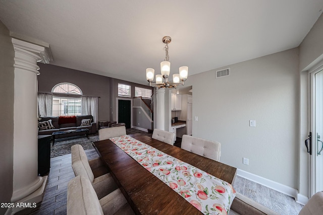 7110 N 28th Dr, Phoenix, AZ 85051 - dining room featuring a chandelier, dark wood-type flooring, baseboards, and stairs