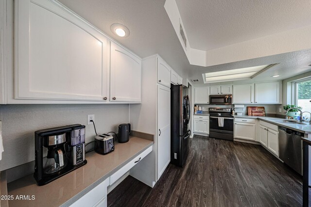 7110 N 28th Dr, Phoenix, AZ 85051 - kitchen with stainless steel appliances, a sink, dark wood-type flooring, white cabinetry, and a textured ceiling