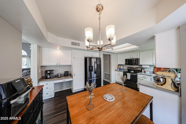 7110 N 28th Dr, Phoenix, AZ 85051 - kitchen featuring refrigerator with ice dispenser, range with electric cooktop, black microwave, a raised ceiling, and a chandelier
