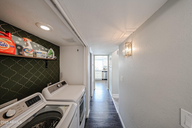 7110 N 28th Dr, Phoenix, AZ 85051 - laundry room featuring baseboards, washing machine and clothes dryer, dark wood-type flooring, and a textured ceiling