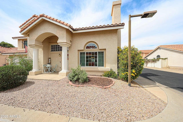 7110 N 28th Dr, Phoenix, AZ 85051 - mediterranean / spanish home with stucco siding, a tile roof, and a chimney