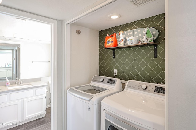7110 N 28th Dr, Phoenix, AZ 85051 - laundry room with washer and clothes dryer and wood finished floors