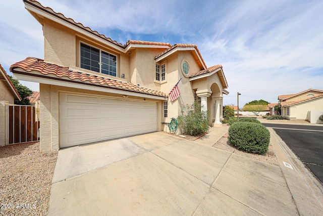 7110 N 28th Dr, Phoenix, AZ 85051 - view of front of house featuring concrete driveway, a tiled roof, stucco siding, an attached garage, and fence