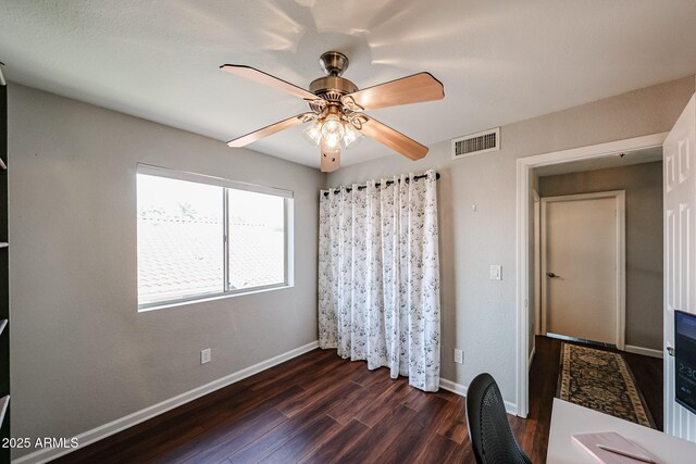 7110 N 28th Dr, Phoenix, AZ 85051 - unfurnished bedroom with dark wood-type flooring, baseboards, and a ceiling fan