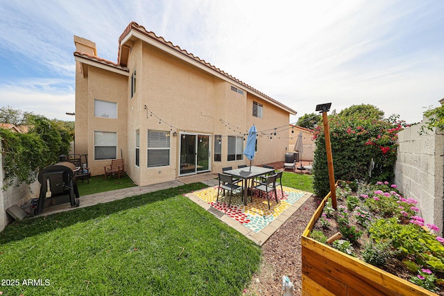 7110 N 28th Dr, Phoenix, AZ 85051 - rear view of house featuring a garden, stucco siding, a tile roof, and a patio area