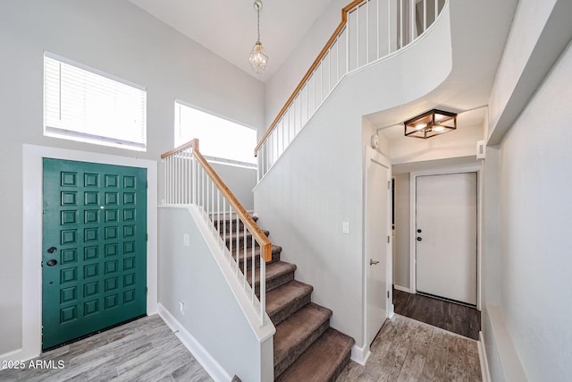 7110 N 28th Dr, Phoenix, AZ 85051 - entryway featuring a towering ceiling, wood finished floors, stairs, and a chandelier