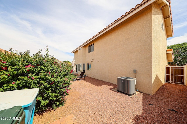 7110 N 28th Dr, Phoenix, AZ 85051 - view of home's exterior featuring stucco siding, cooling unit, fence, and a patio area