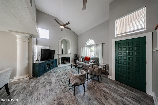 7110 N 28th Dr, Phoenix, AZ 85051 - living area featuring high vaulted ceiling, a ceiling fan, ornate columns, wood finished floors, and a fireplace