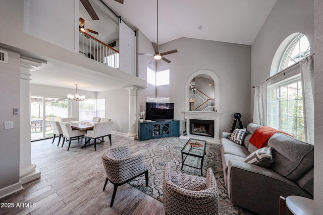 7110 N 28th Dr, Phoenix, AZ 85051 - living room with a ceiling fan, healthy amount of natural light, a chandelier, a fireplace, and high vaulted ceiling