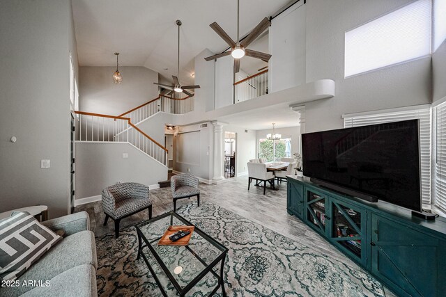 7110 N 28th Dr, Phoenix, AZ 85051 - living room featuring stairway, a ceiling fan, high vaulted ceiling, a chandelier, and wood finished floors