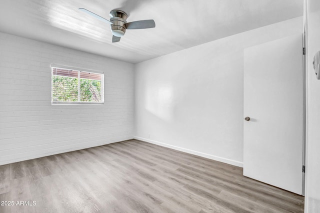 31 W 2nd St, Mesa, AZ 85201 - empty room with a ceiling fan, wood finished floors, and brick wall