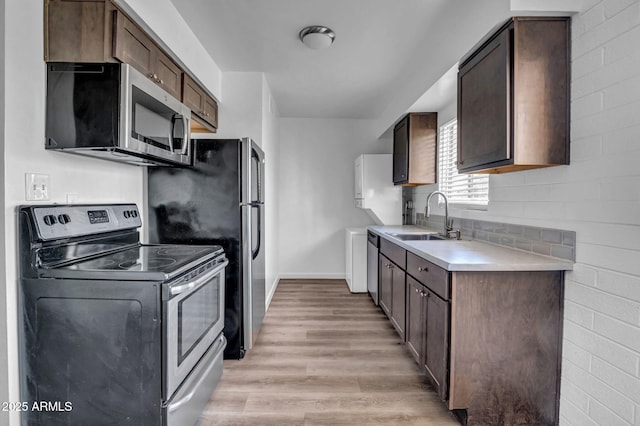 31 W 2nd St, Mesa, AZ 85201 - kitchen with appliances with stainless steel finishes, light countertops, light wood-style flooring, and dark brown cabinetry