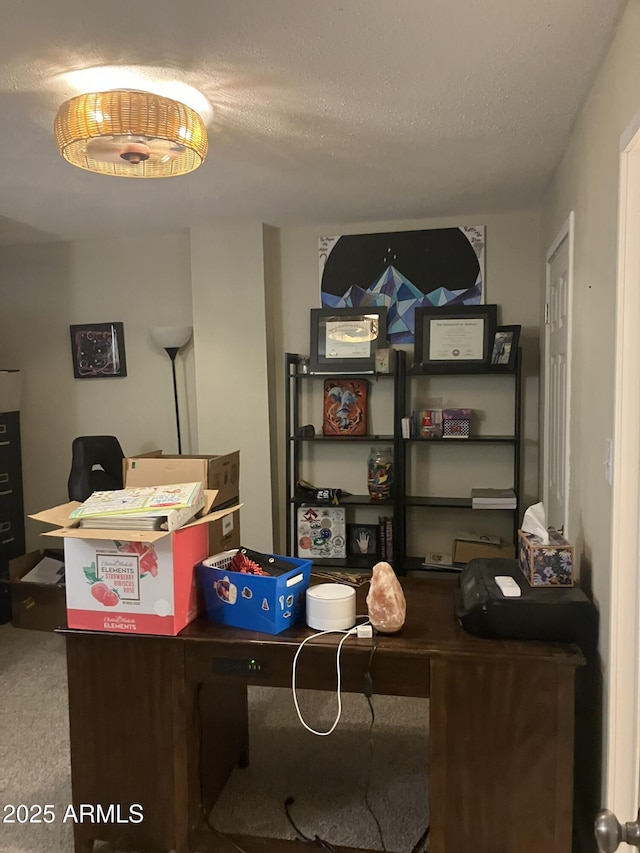 carpeted office featuring a textured ceiling