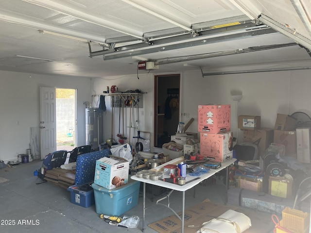 garage featuring a garage door opener and electric water heater