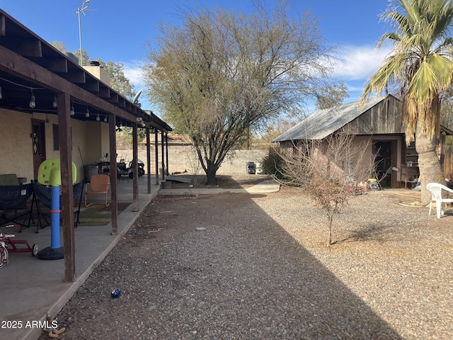 view of yard with a patio area and an outbuilding