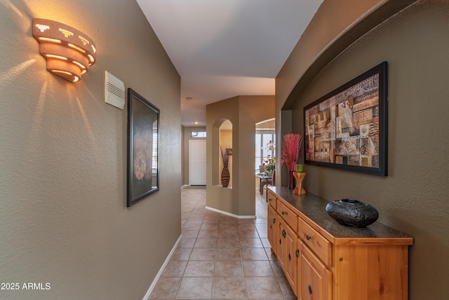 hall featuring light tile patterned flooring