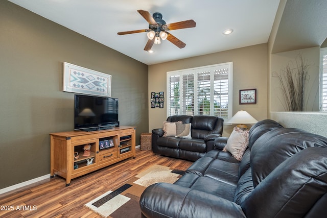 living room with hardwood / wood-style flooring and ceiling fan