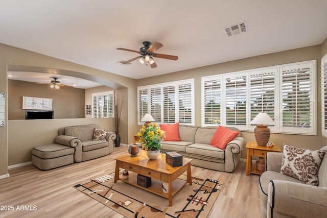 living room with ceiling fan and light hardwood / wood-style flooring