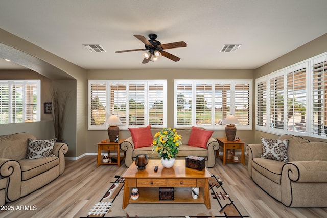 living room with ceiling fan and light wood-type flooring