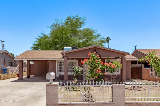 3525 W Latham St, Phoenix, AZ 85009 - single story home with a fenced front yard, driveway, an attached carport, covered porch, and stucco siding