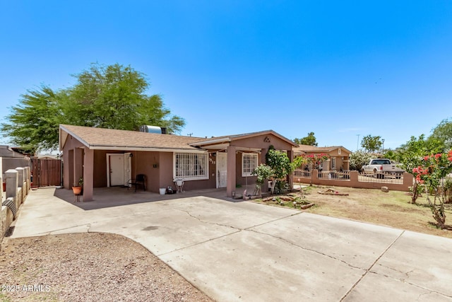 3525 W Latham St, Phoenix, AZ 85009 - ranch-style home with concrete driveway, stucco siding, fence, a gate, and a carport