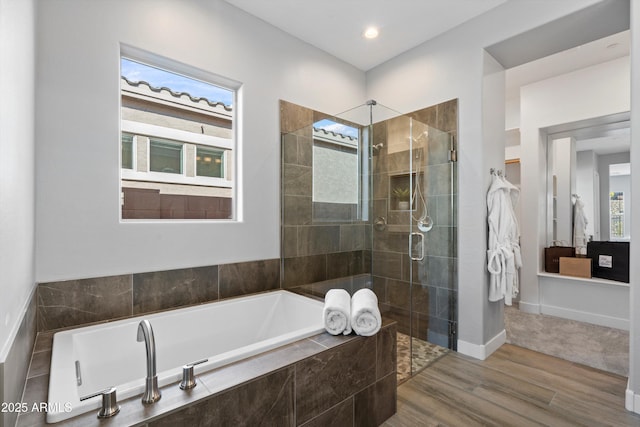 bathroom featuring hardwood / wood-style flooring and shower with separate bathtub