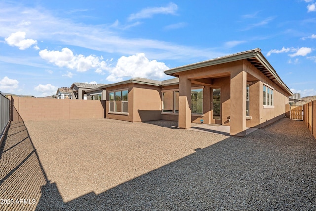 rear view of property featuring a patio area