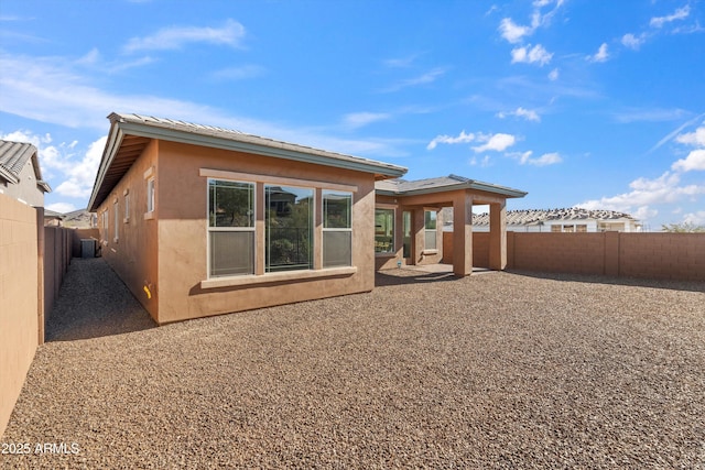 back of house with a patio