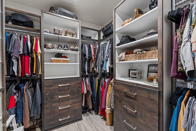 walk in closet featuring light hardwood / wood-style flooring