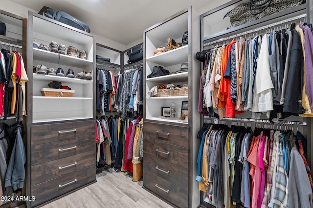 walk in closet featuring light hardwood / wood-style flooring