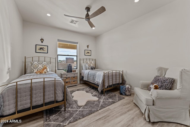 bedroom with wood-type flooring and ceiling fan