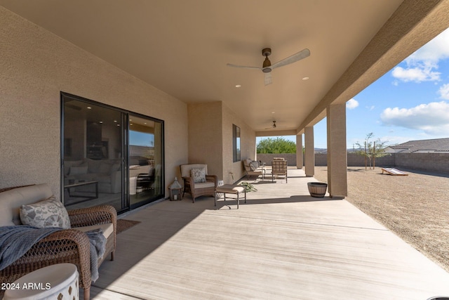 view of patio / terrace with a deck, ceiling fan, and an outdoor living space