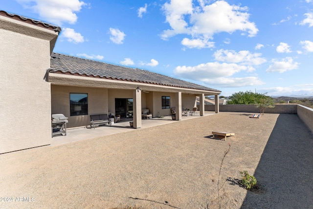 back of property with a patio