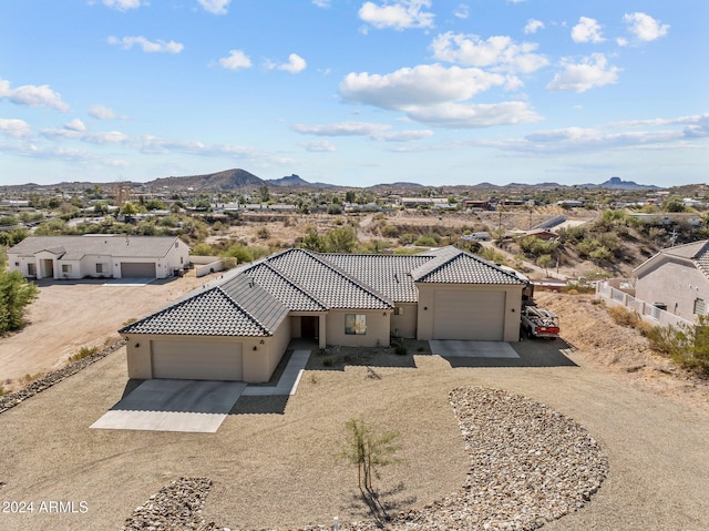 view of front of house featuring a garage and a mountain view